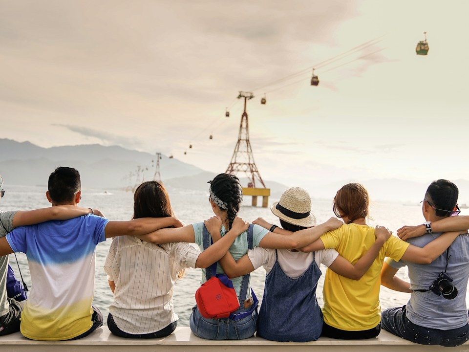 Friends gathered together outdoors, stock photograph
